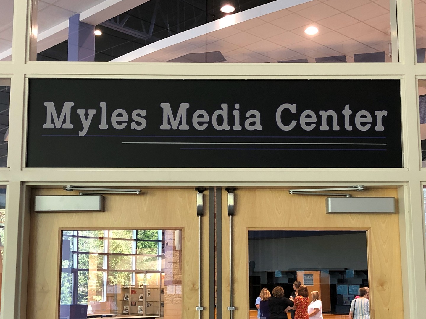 A banner above doors of the Fremont Middle School Media Center that reads 'Myles Media Center'